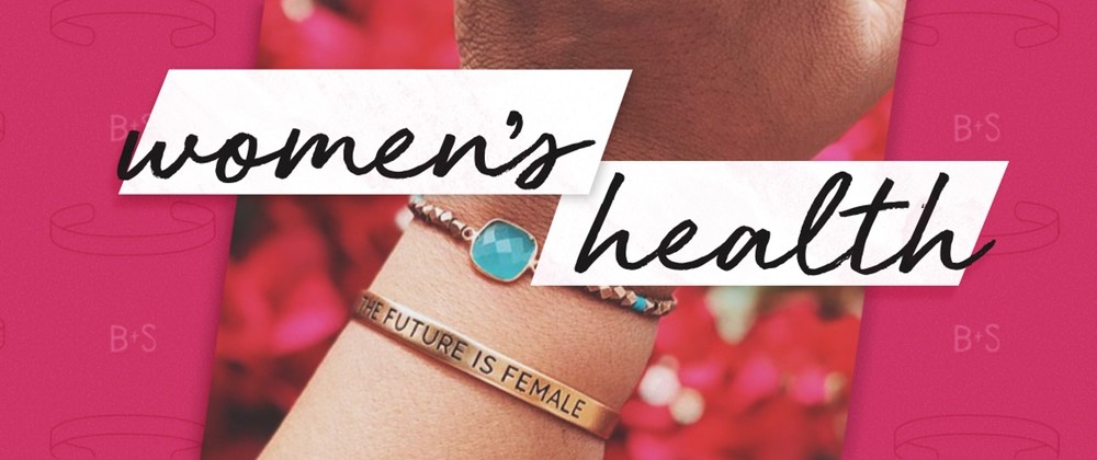 Women's health concept with female hand wearing turquoise ring and "THE FUTURE IS FEMALE" bracelet on pink background